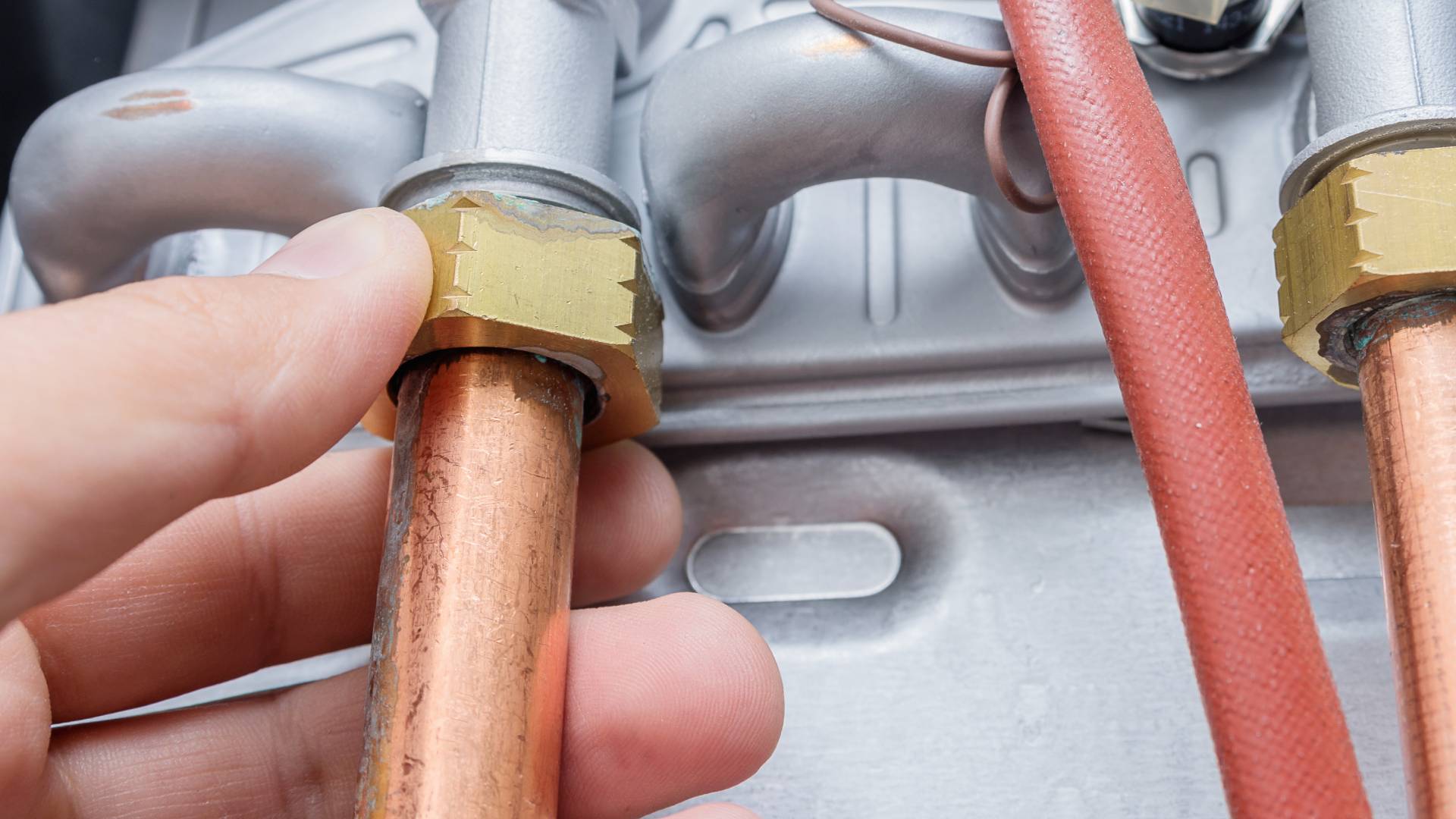 Close up of copper pipe connection and brass fitting on domestic boiler system
