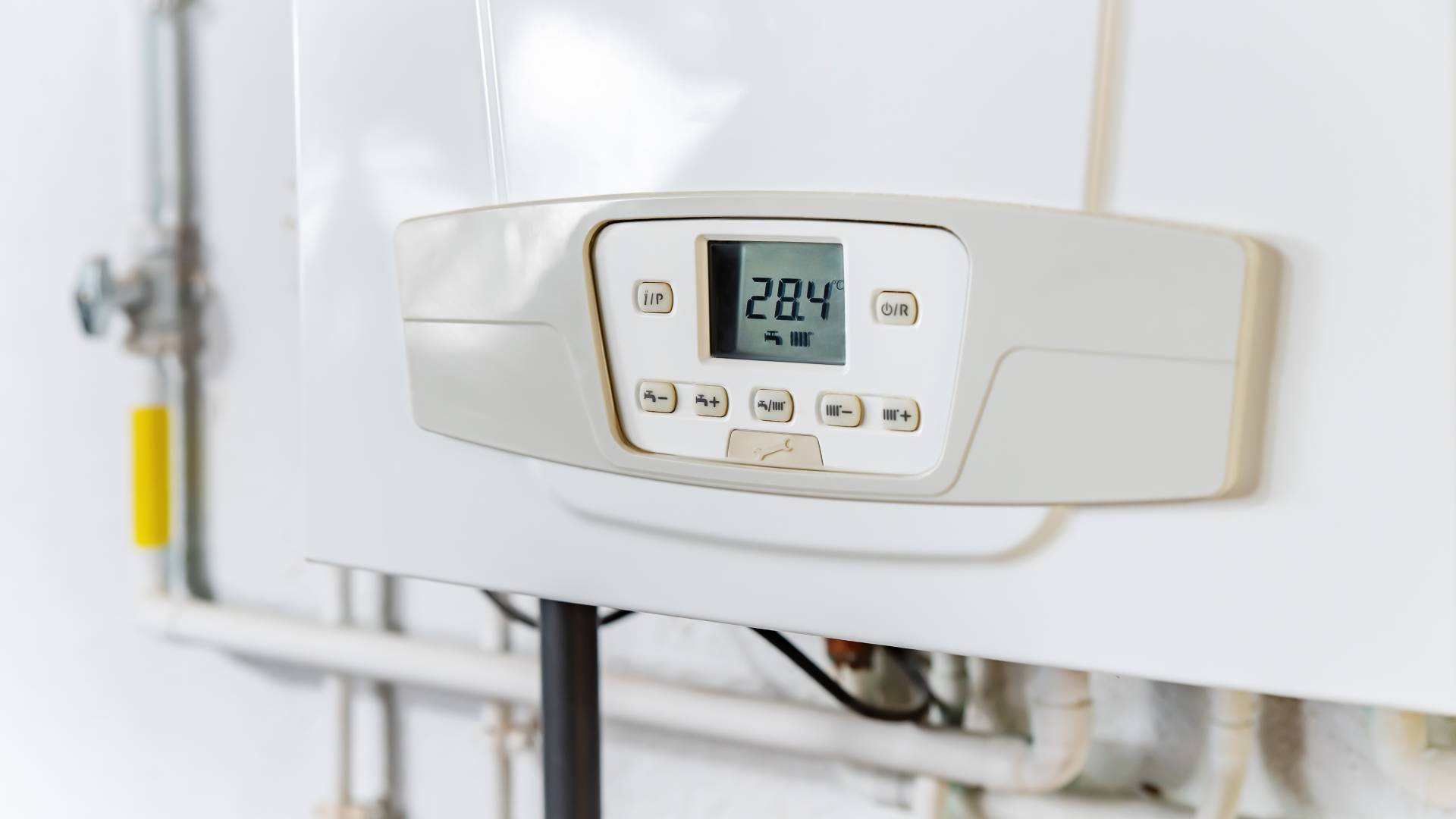 Digital boiler control panel displaying temperature settings on domestic heating system