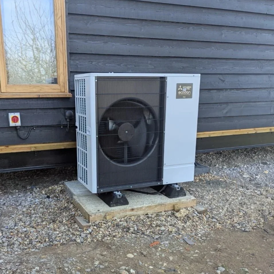 Mitsubishi Heat Pump Servicing Mitsubishi air source heat pump unit installed externally beside residential property for heat pump servicing
