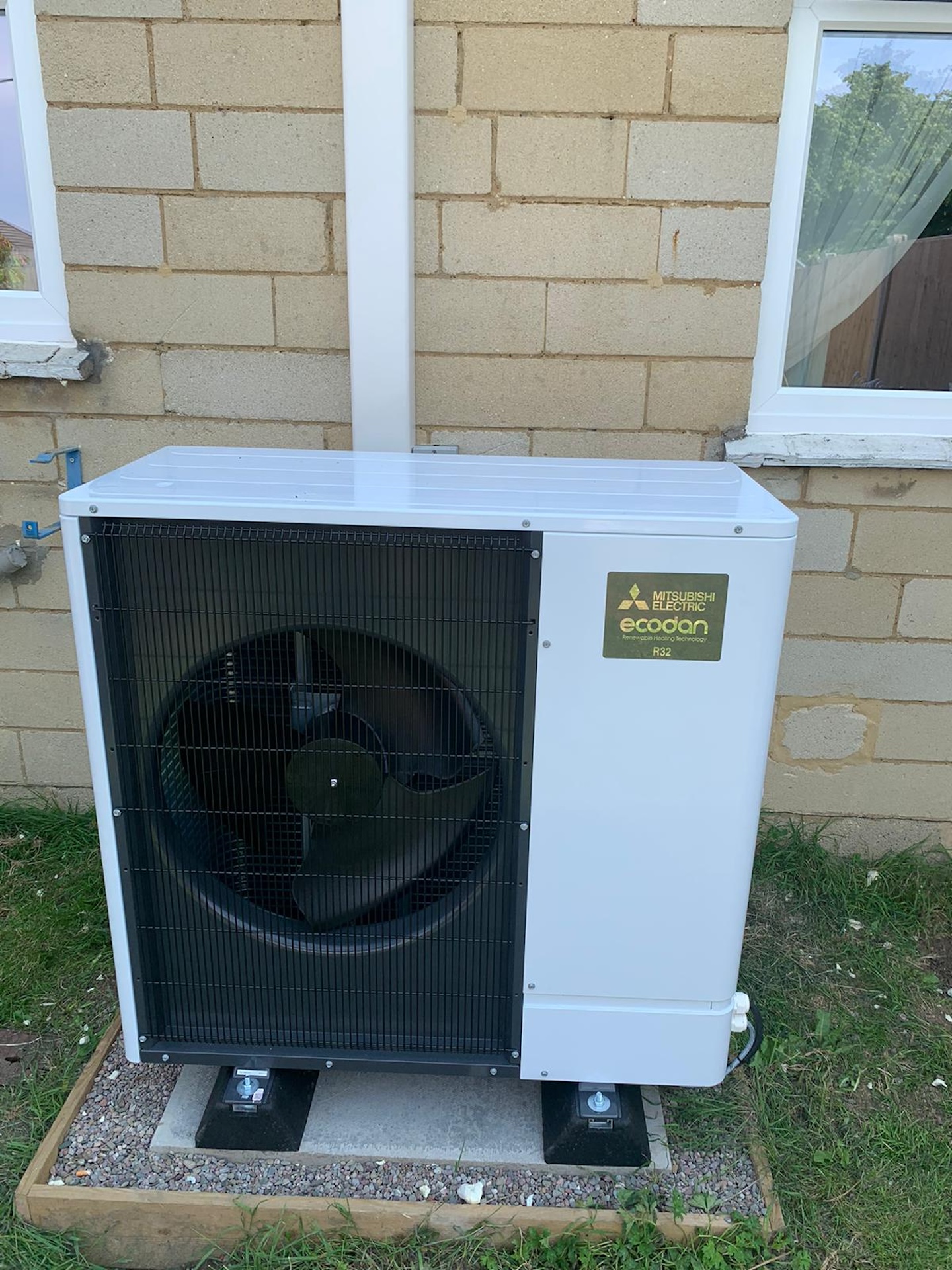 Mitsubishi Electric Ecodan air source heat pump unit installed outside residential property for heating system servicing