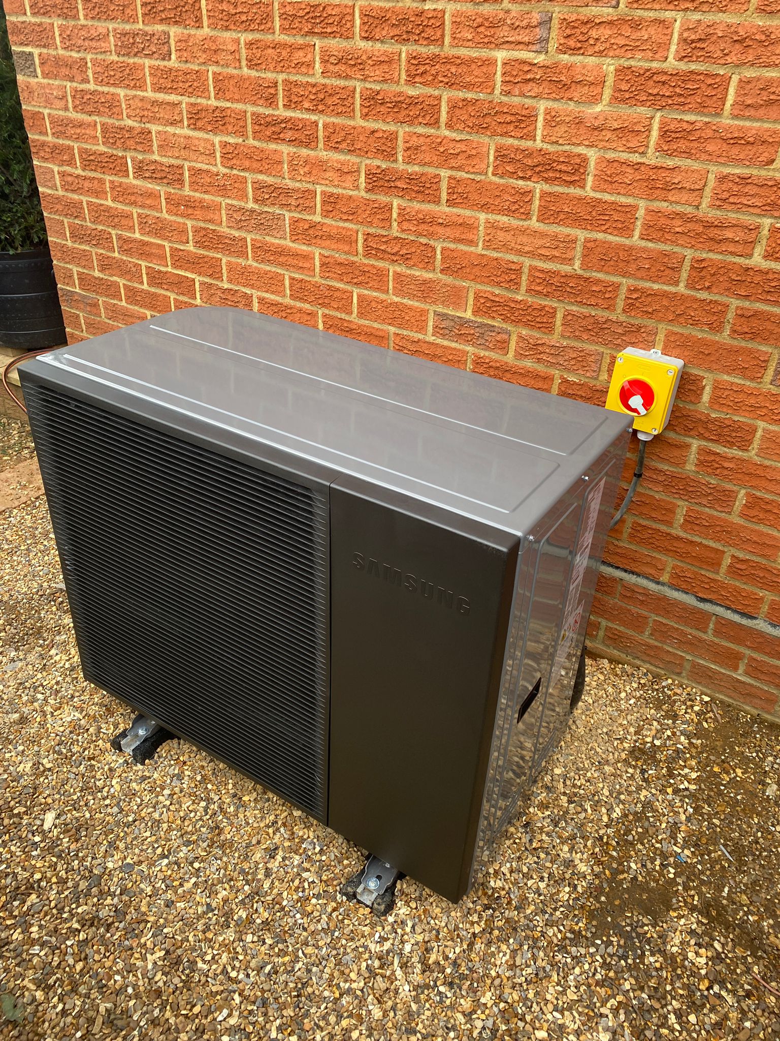 Unknown-3 Samsung air source heat pump unit installed externally beside residential brick wall